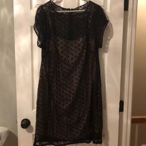 Sheer black flowered dress with tan underlay.